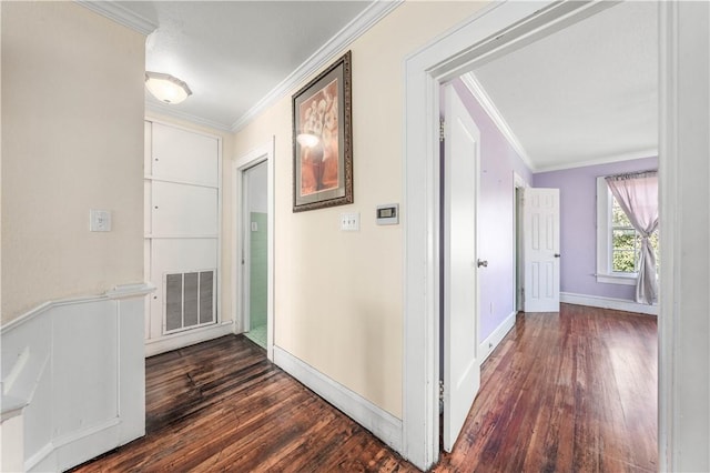 corridor featuring ornamental molding and dark hardwood / wood-style floors