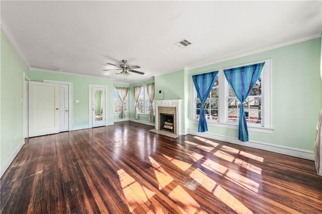 unfurnished living room featuring a brick fireplace, crown molding, and hardwood / wood-style floors