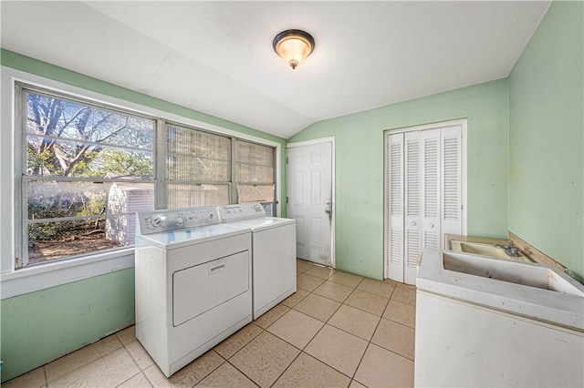 laundry area with light tile patterned floors, sink, and washer and dryer