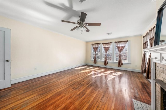 unfurnished living room with ceiling fan, ornamental molding, a fireplace, and dark hardwood / wood-style flooring