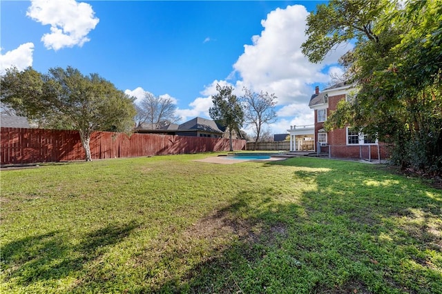 view of yard with a fenced in pool