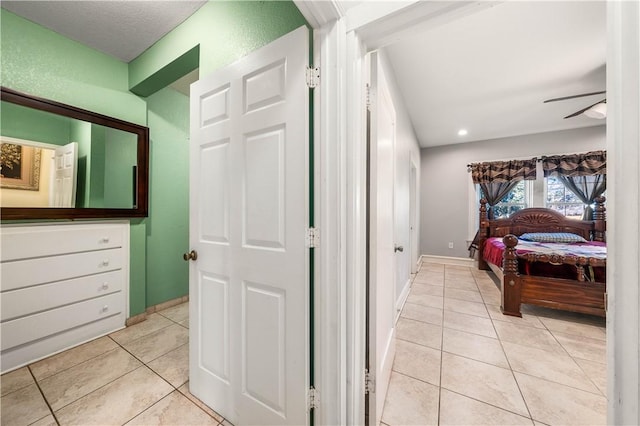 bedroom featuring light tile patterned floors and ceiling fan