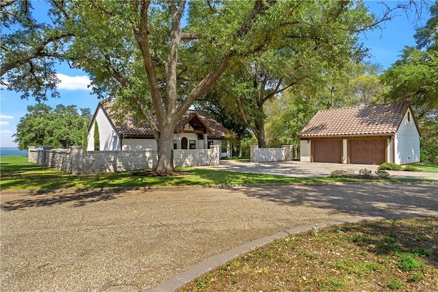 view of front of home featuring a garage and an outdoor structure