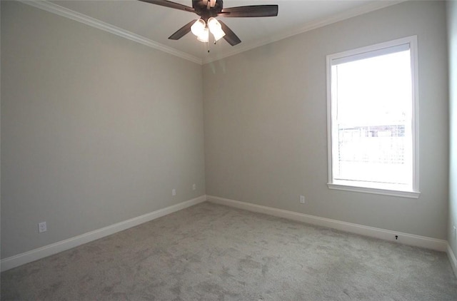 empty room featuring ceiling fan, light colored carpet, and ornamental molding