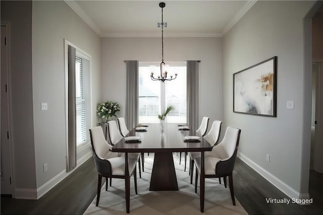 dining area featuring dark hardwood / wood-style flooring, an inviting chandelier, and ornamental molding