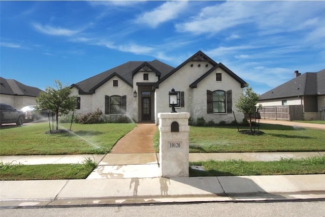 french provincial home with a front lawn