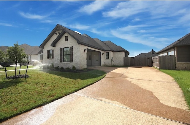 french country inspired facade with a front yard