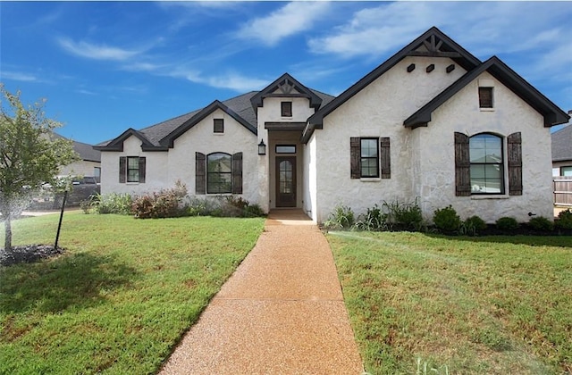 french country inspired facade featuring a front lawn