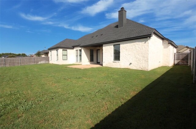 back of house featuring a yard