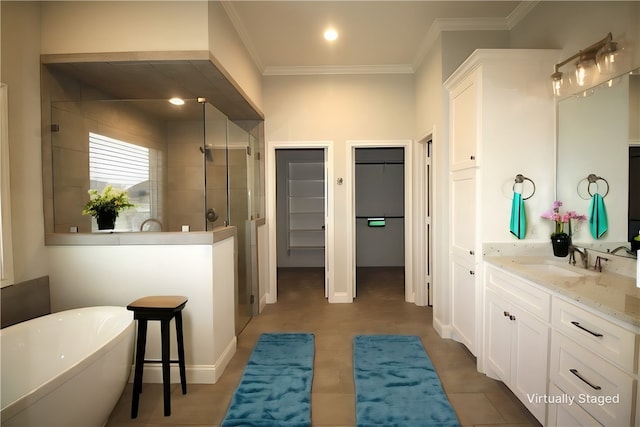 bathroom featuring tile patterned floors, vanity, separate shower and tub, and ornamental molding