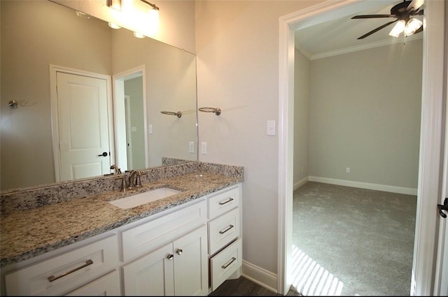 bathroom featuring ceiling fan, vanity, and ornamental molding