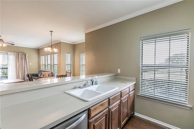 kitchen with pendant lighting, dishwasher, sink, dark hardwood / wood-style flooring, and ornamental molding