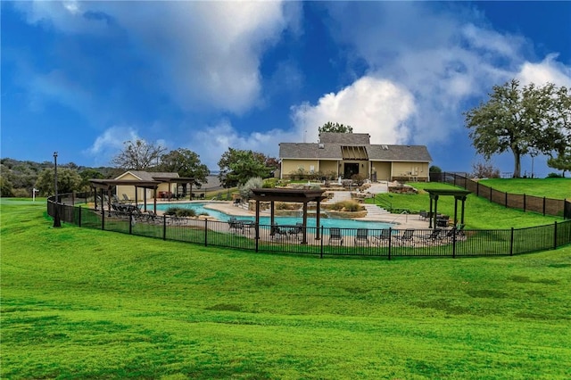 view of swimming pool featuring an outdoor fireplace, a patio area, and a lawn