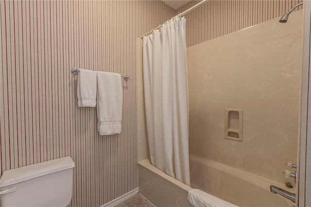 bathroom with tile patterned floors, toilet, and shower / bath combo with shower curtain