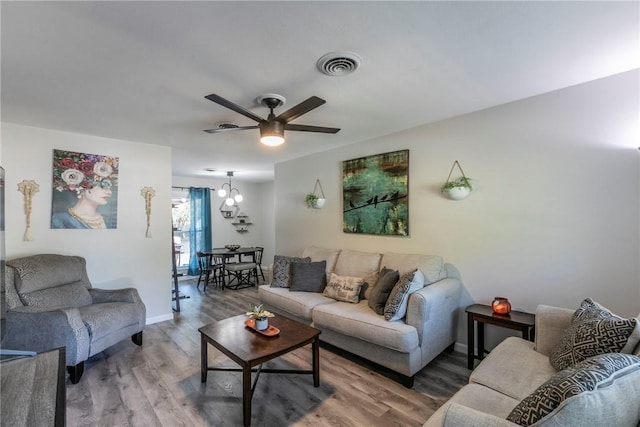 living room with ceiling fan and hardwood / wood-style flooring