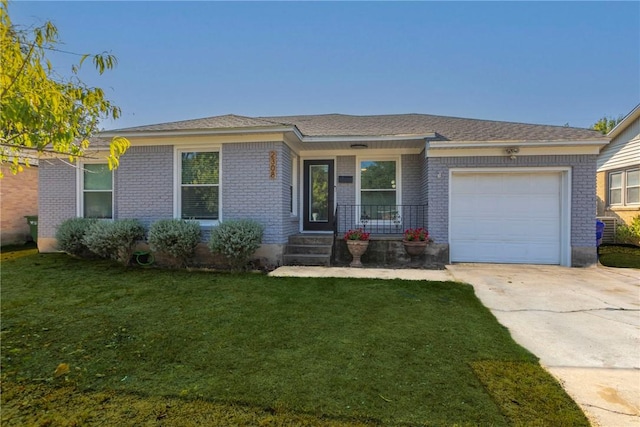 ranch-style home featuring a garage and a front lawn