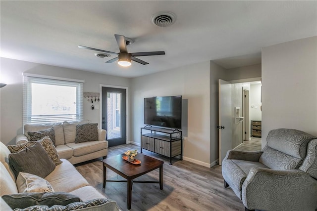 living room with ceiling fan and hardwood / wood-style flooring