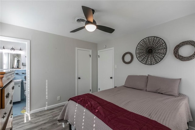 bedroom with ceiling fan, light hardwood / wood-style floors, and ensuite bath