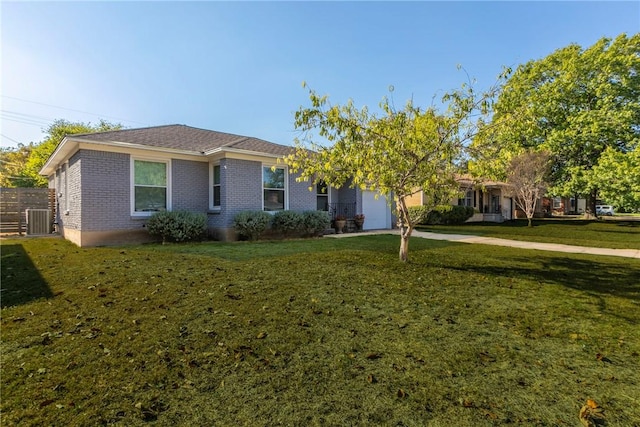 view of front of house with a garage, central air condition unit, and a front yard