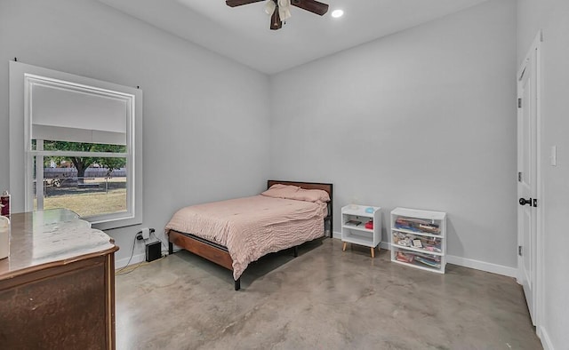 bedroom with ceiling fan and concrete floors