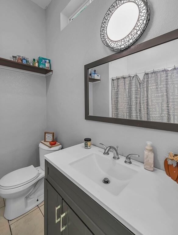 bathroom with tile patterned floors, vanity, and toilet