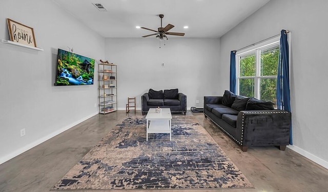 living room with ceiling fan and concrete floors