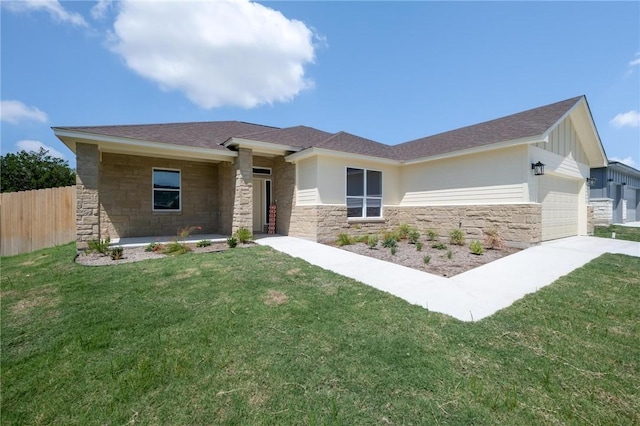 view of front of house with a front yard and a garage