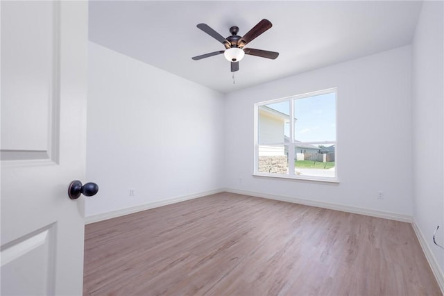 empty room with light hardwood / wood-style floors and ceiling fan