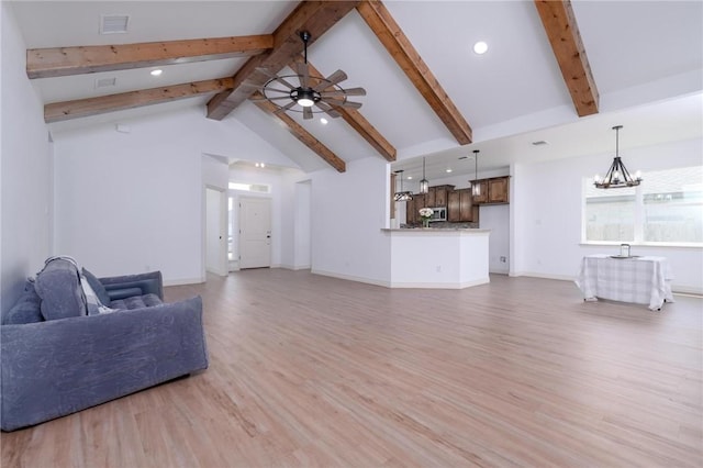 living room with lofted ceiling with beams, ceiling fan with notable chandelier, and light hardwood / wood-style flooring