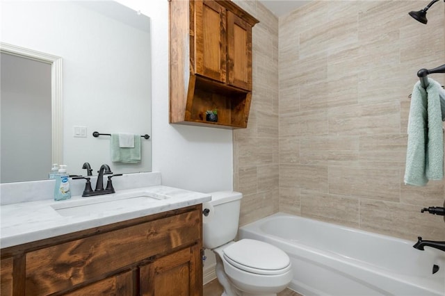 full bathroom with tiled shower / bath, vanity, and toilet