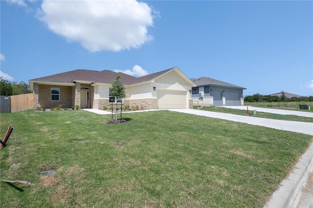 view of front of property featuring a garage and a front lawn