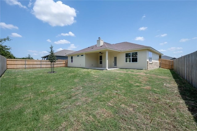 back of house featuring ceiling fan, a yard, and a patio