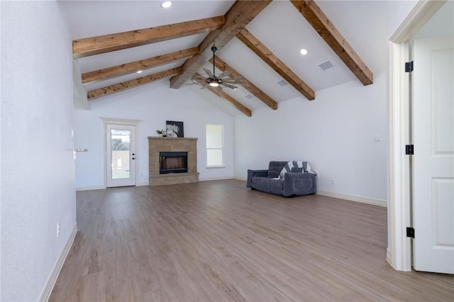 unfurnished room with beam ceiling, light wood-type flooring, high vaulted ceiling, and ceiling fan