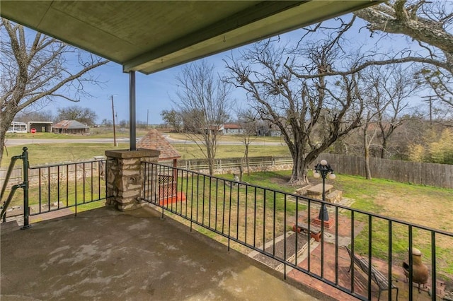 view of patio / terrace featuring covered porch and fence