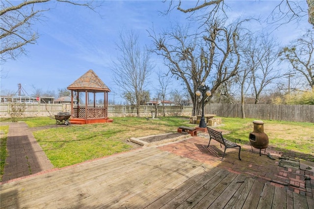 wooden deck with a gazebo, a lawn, and a fenced backyard