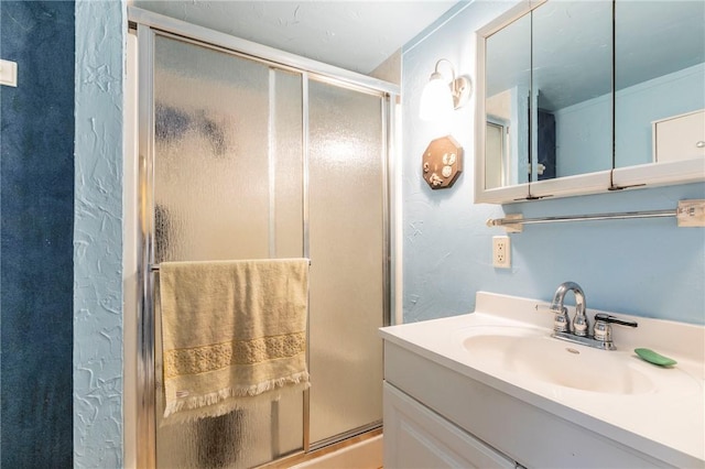 bathroom with vanity and a stall shower