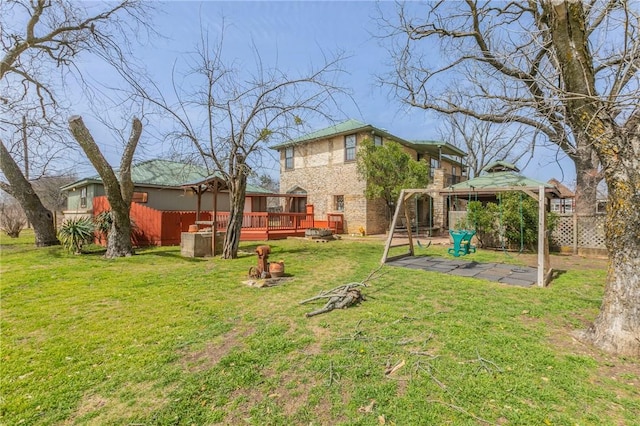 view of yard with a gazebo, fence, a deck, and a patio area