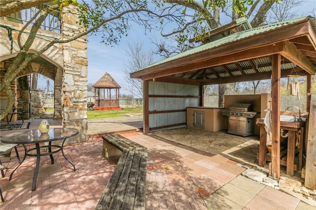 view of patio with outdoor dining space, a gazebo, area for grilling, and grilling area