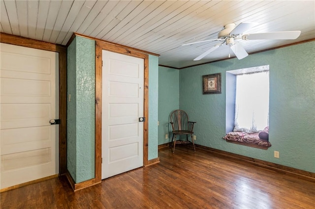 unfurnished room with wood ceiling, ornamental molding, dark wood-style flooring, and a textured wall