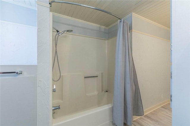 bathroom with shower / bath combo with shower curtain, ornamental molding, wood finished floors, baseboards, and wood ceiling