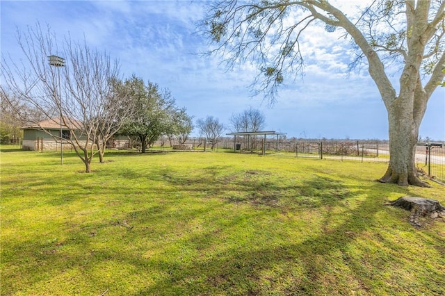 view of yard featuring a rural view and fence