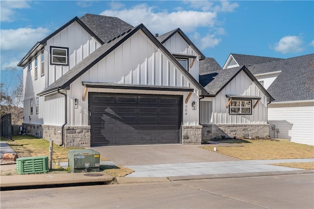 view of front of house featuring a garage and central AC