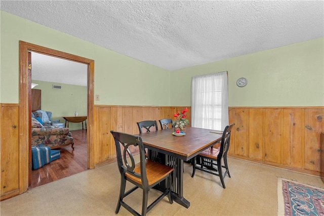 dining area featuring a textured ceiling