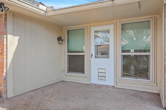 view of exterior entry featuring a patio