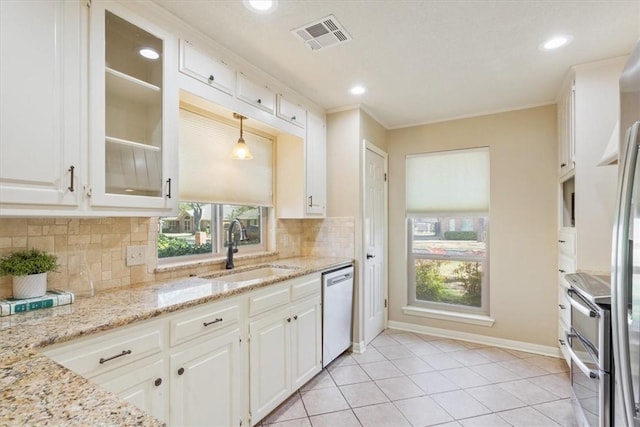 kitchen featuring a sink, visible vents, dishwasher, and white cabinetry