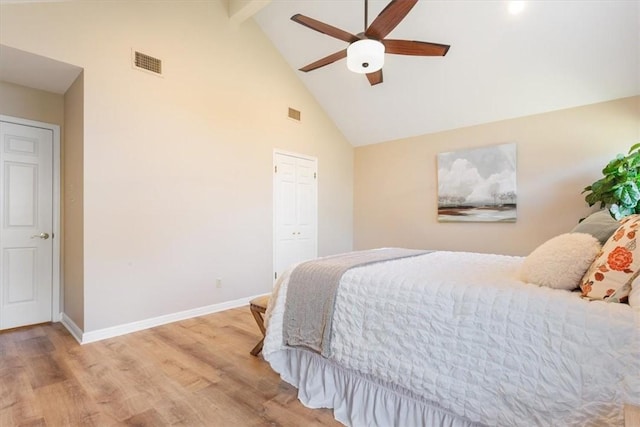 bedroom featuring visible vents, high vaulted ceiling, baseboards, and wood finished floors