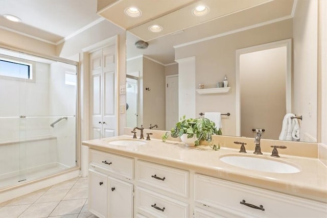 full bathroom featuring a sink, ornamental molding, a shower stall, and tile patterned flooring