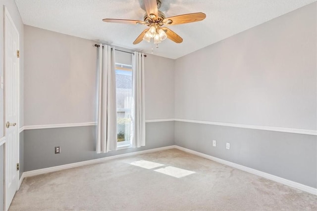 empty room with baseboards, a healthy amount of sunlight, ceiling fan, and carpet flooring