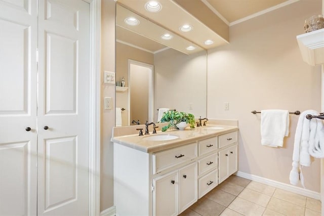 bathroom featuring tile patterned floors, ornamental molding, double vanity, and a sink