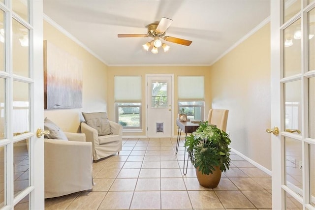 living area with crown molding, light tile patterned floors, french doors, and baseboards